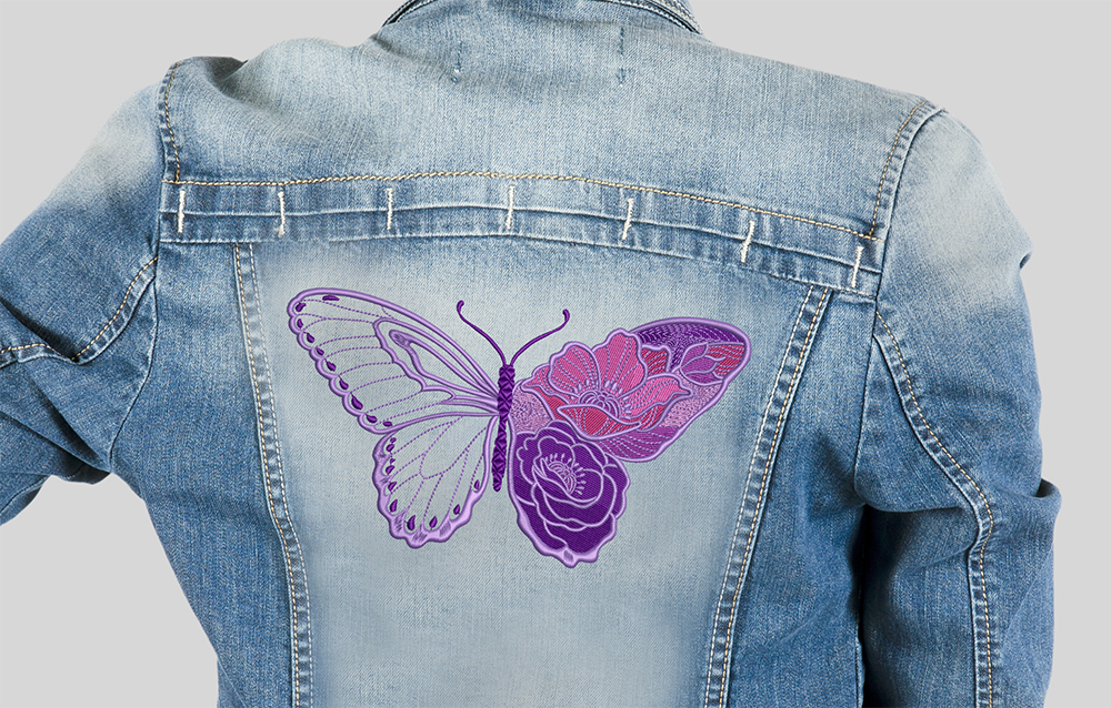 Denim jacket showcasing a detailed embroidered butterfly on the back.